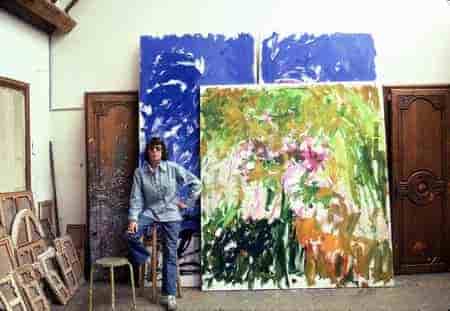 Joan Mitchell in her art studio in front of her painting.